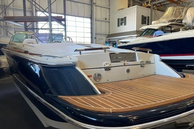 Slide: The Image of 2021 Chris-Craft Launch 27 boat with elegant wood deck in a marina setting. - 5