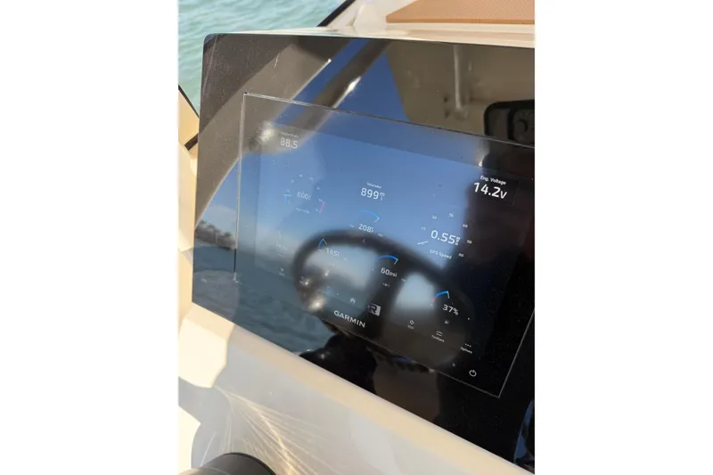 Slide: The Image of 2024 Scout 240 XSF boat dashboard with Garmin display showing engine data. - 12