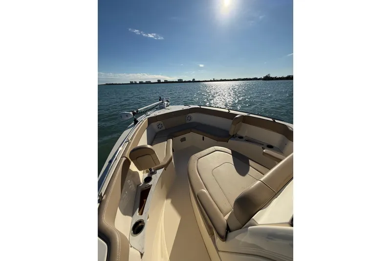 Slide: The Image of 2024 Scout 240 XSF boat interior with sunlit water view. - 14