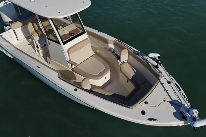 Slide: The Image of 2024 Scout 240 XSF boat with sleek design on calm water. - 19