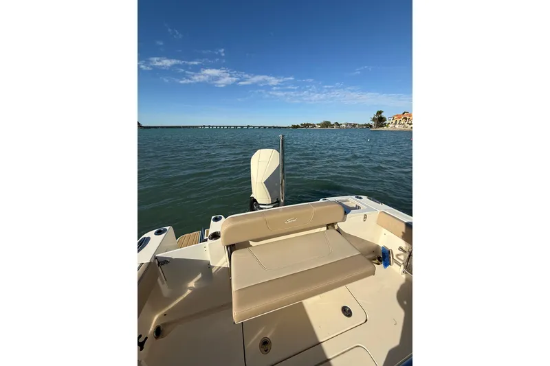 Slide: The Image of 2024 Scout 240 XSF boat on calm water with clear blue sky. - 7