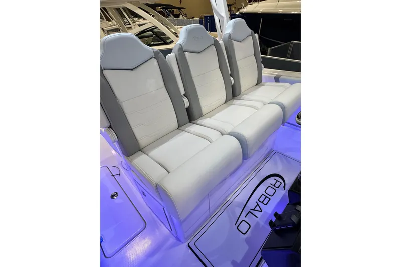 Slide: The Image of 2026 Robalo R300 Center Console boat with illuminated seating and sleek design. - 11