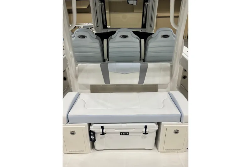 Slide: The Image of 2026 Robalo R300 Center Console boat interior with seating and Yeti cooler. - 2