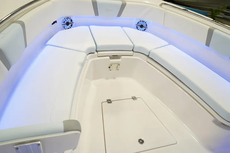 Slide: The Image of 2026 Robalo R300 Center Console boat interior with cushioned seating and ambient lighting. - 21