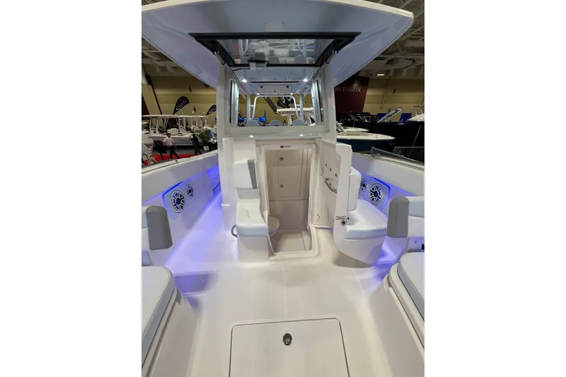 Slide: The Image of 2026 Robalo R300 Center Console boat interior with blue LED lighting and seating. - 22
