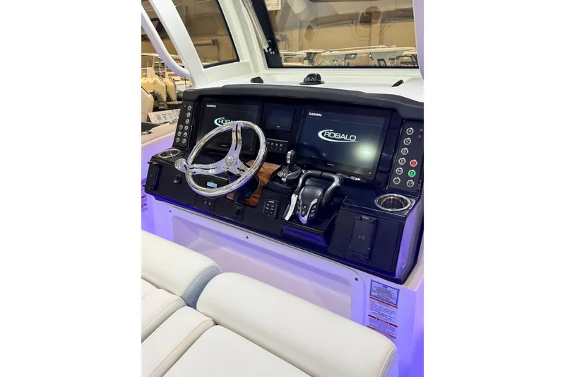 Slide: The Image of 2026 Robalo R300 Center Console boat dashboard with advanced controls and dual displays. - 3