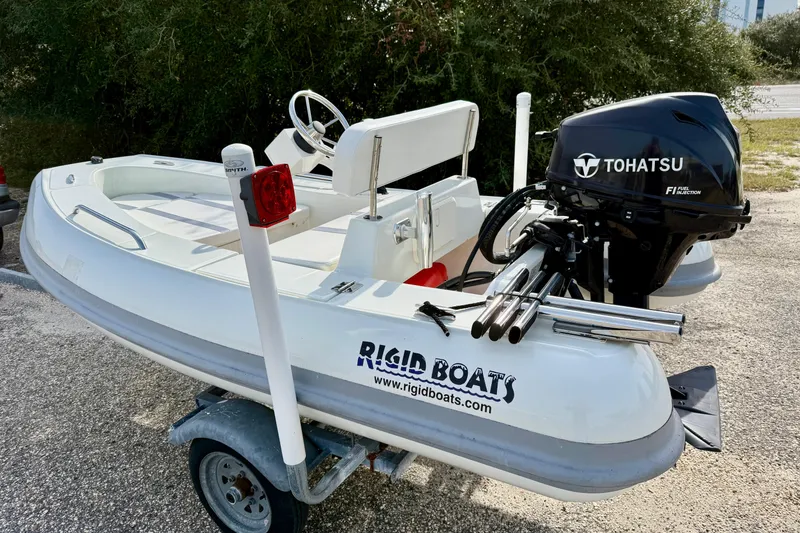 Slide: The Image of 2023 Rigid Boats 10 Sport with Tohatsu engine on trailer. - 1