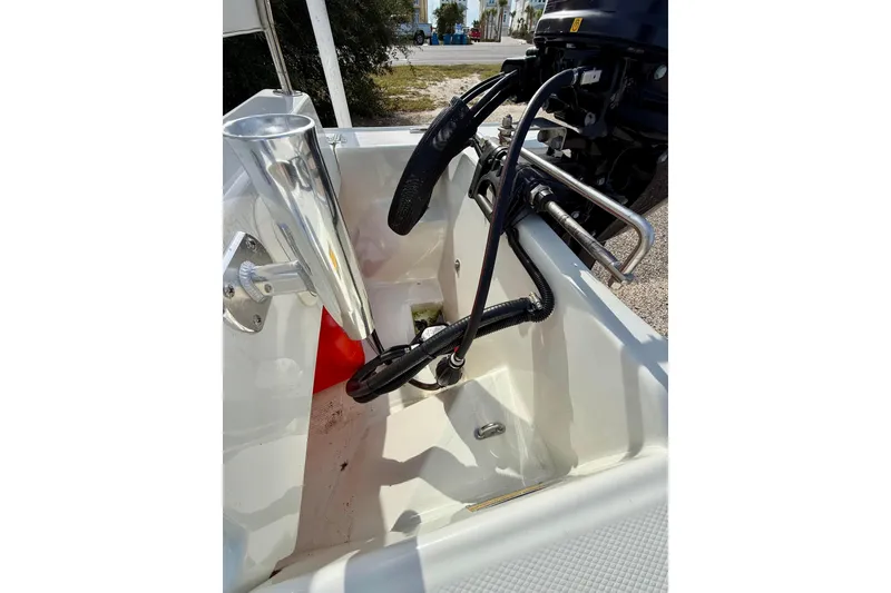 Slide: The Image of 2023 Rigid Boats 10 Sport interior with steering and control cables. - 11