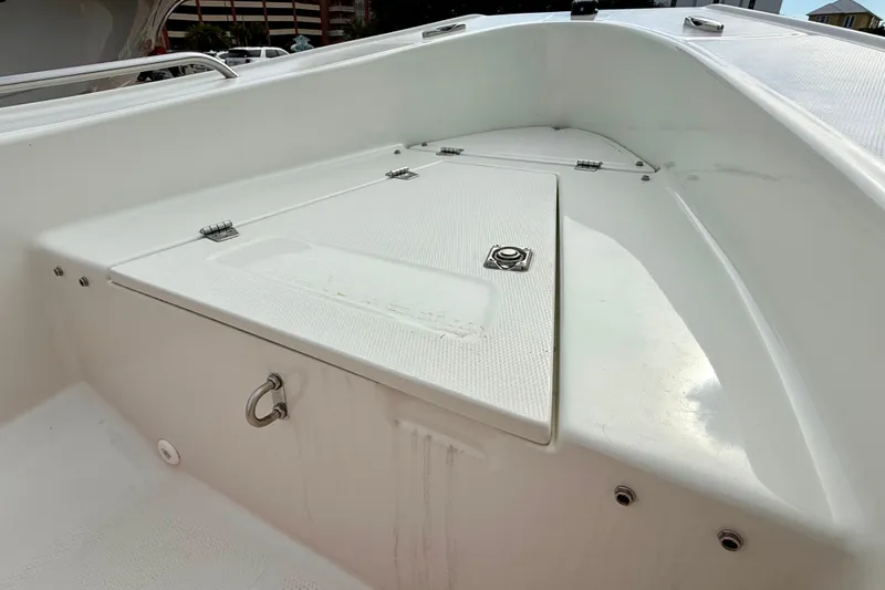 Slide: The Image of 2023 Rigid Boats 10 Sport deck view, featuring storage compartment and sleek design. - 12