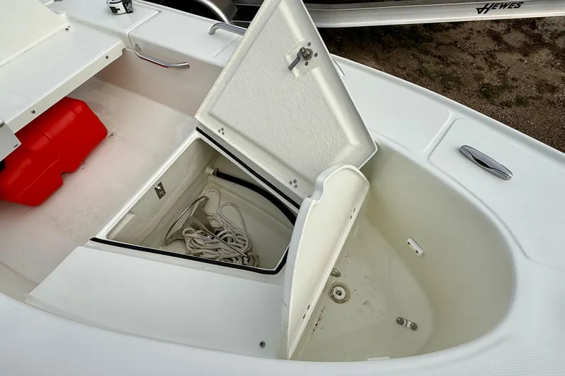 Slide: The Image of 2023 Rigid Boats 10 Sport storage compartment with rope and red container. - 13