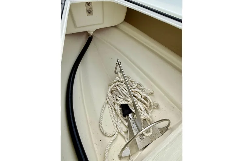 Slide: The Image of 2023 Rigid Boats 10 Sport anchor compartment with rope and anchor. - 14