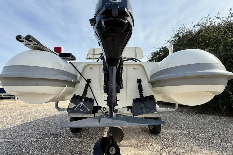 Slide: The Image of 2023 Rigid Boats 10 Sport, rear view with motor and pontoons. - 4