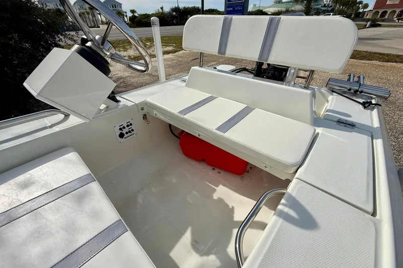Slide: The Image of 2023 Rigid Boats 10 Sport interior with white seating and steering wheel. - 9
