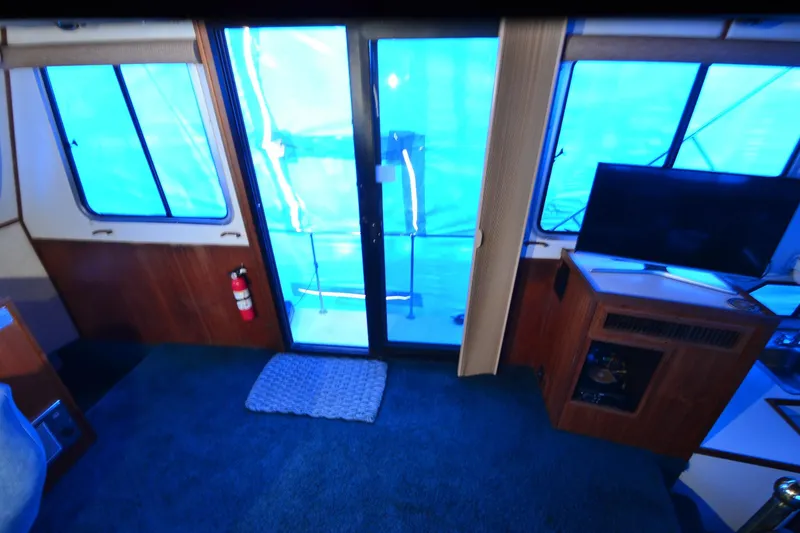 Slide: The Image of Interior of 1994 Harbor Master 46 yacht with blue carpet and TV. - 10