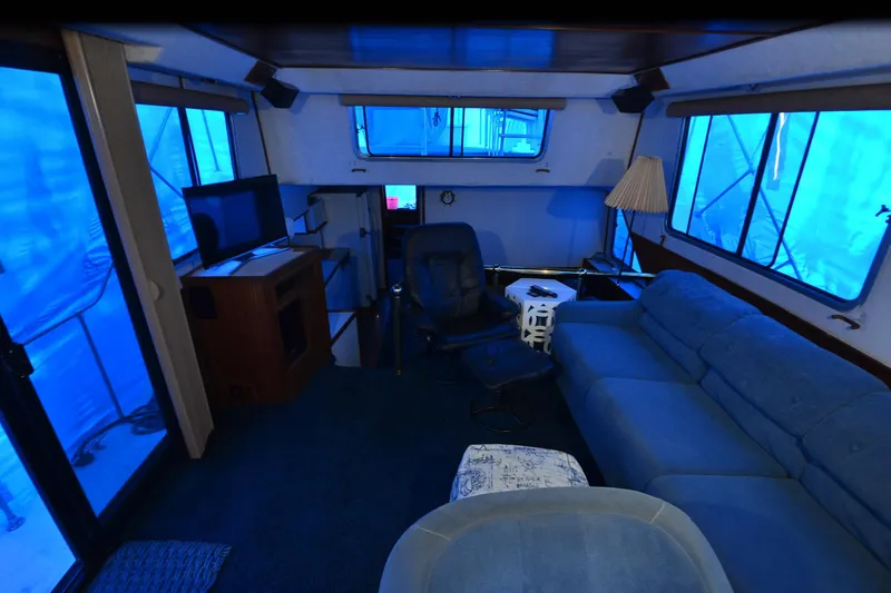 Slide: The Image of Interior of 1994 Harbor Master 46 yacht with blue seating and windows. - 11