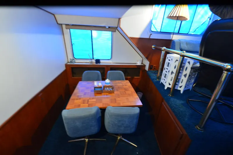 Slide: The Image of Interior of 1994 Harbor Master 46 yacht with dining area and blue chairs. - 13