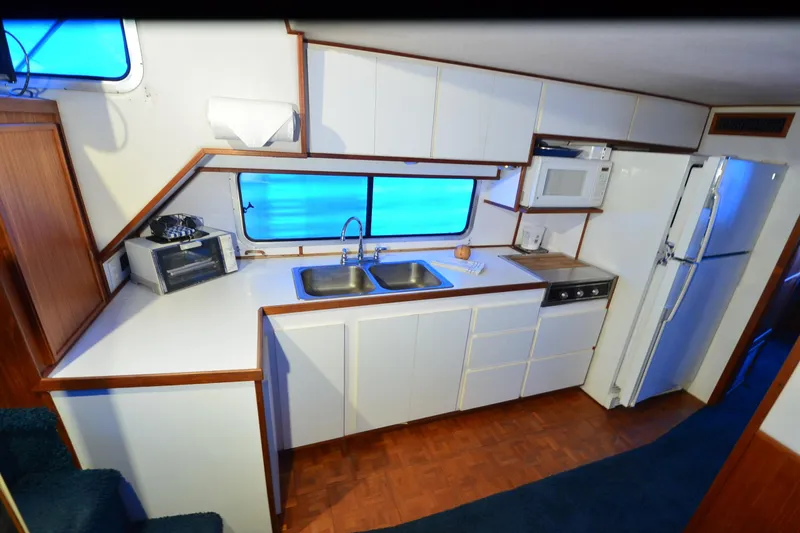 Slide: The Image of 1994 Harbor Master 46 kitchen with white cabinets, double sink, and appliances. - 14