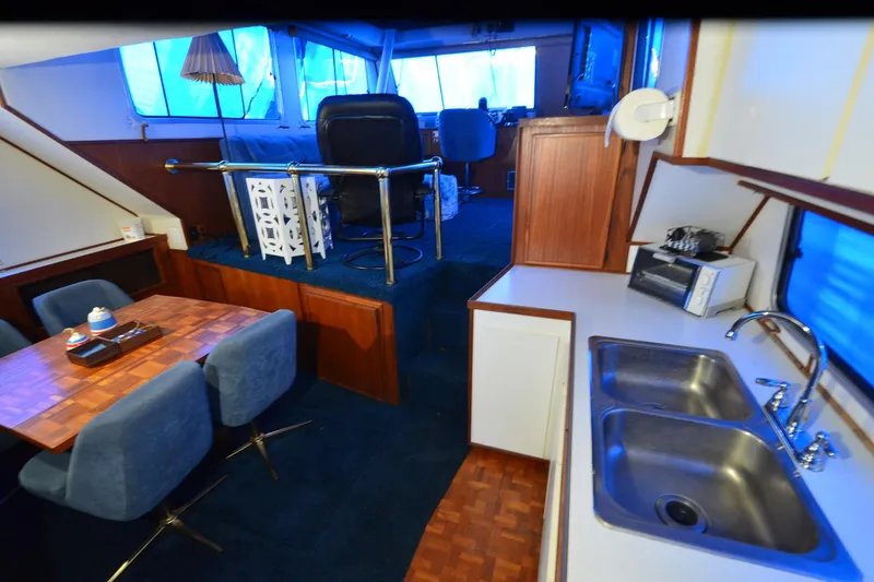 Slide: The Image of Interior of 1994 Harbor Master 46 yacht with kitchen and dining area. - 15