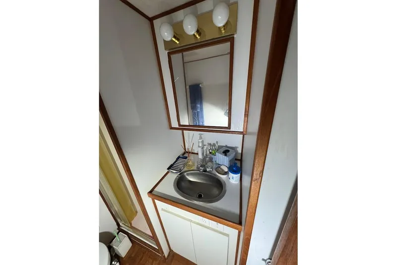 Slide: The Image of Bathroom vanity in 1994 Harbor Master 46 boat with mirror and sink. - 17