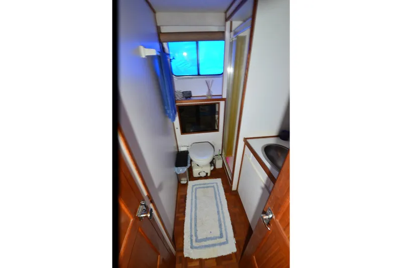Slide: The Image of Bathroom interior of 1994 Harbor Master 46 boat with toilet, sink, and shower. - 18
