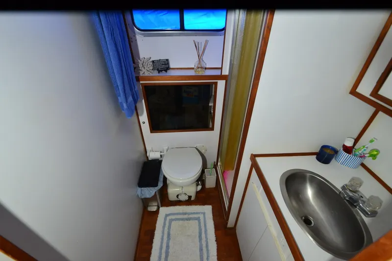 Slide: The Image of Bathroom interior of 1994 Harbor Master 46 boat with sink, toilet, and window. - 19
