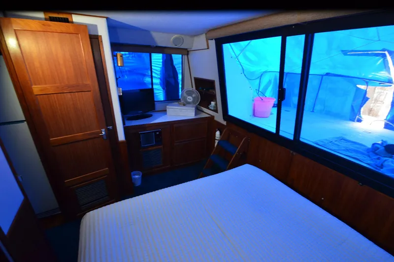Slide: The Image of Cozy cabin interior of 1994 Harbor Master 46 with wood paneling and large windows. - 21