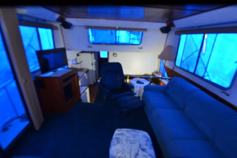 Slide: The Image of Interior of a 1994 Harbor Master 46 boat with blue-lit windows and cozy seating area. - 22