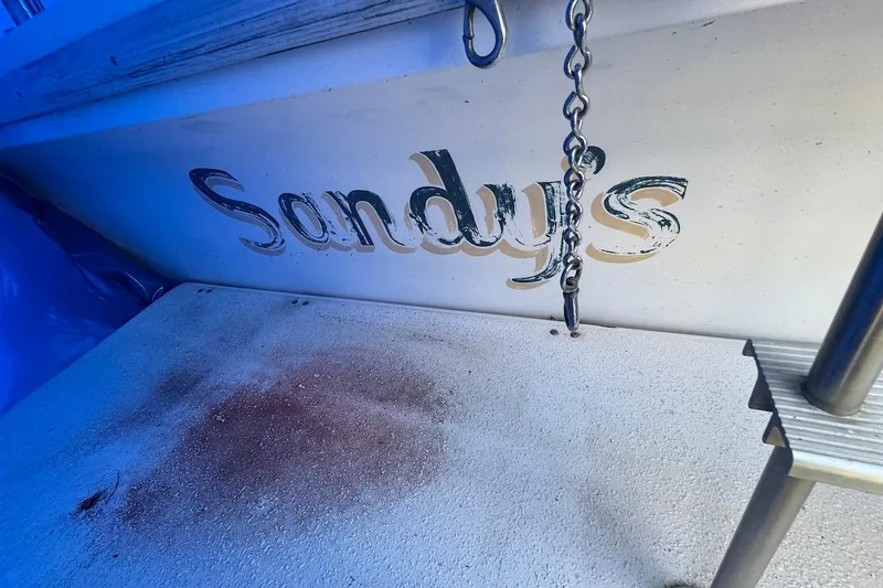 Slide: The Image of 1994 Harbor Master 46 boat with "Sandy's" name and metal chain detail. - 27