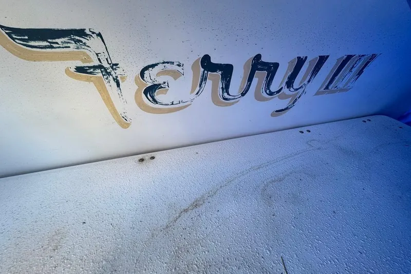 Slide: The Image of Weathered "Ferry" text on 1994 Harbor Master 46 boat surface. - 28