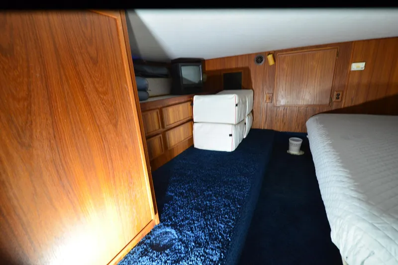 Slide: The Image of Interior cabin of 1994 Harbor Master 46 with wood paneling and blue carpet. - 3