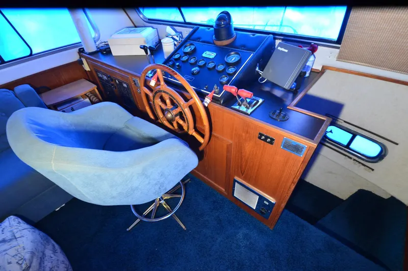 Slide: The Image of Cockpit of 1994 Harbor Master 46 with wooden steering wheel and control panel. - 8