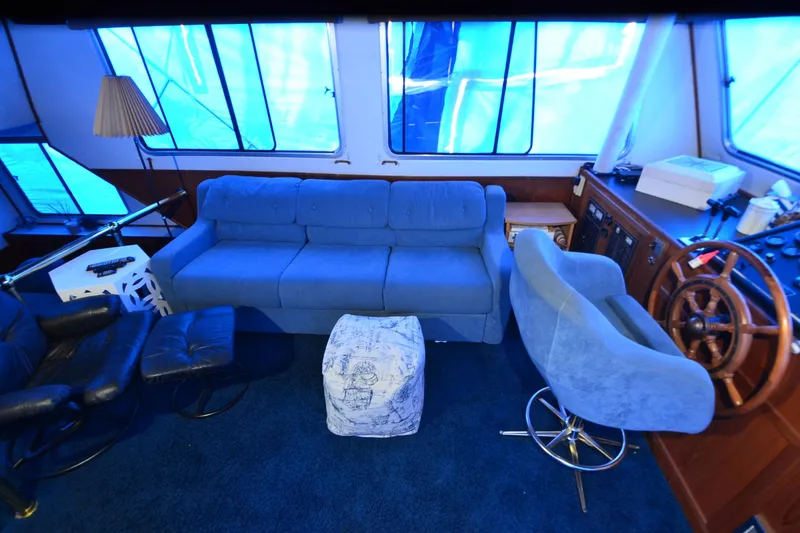 Slide: The Image of Interior of 1994 Harbor Master 46 yacht with blue seating and wooden steering wheel. - 9