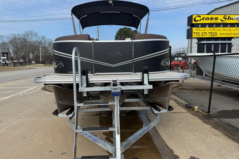 Slide: The Image of 2026 Avalon LSZ QUAD LOUNGER SHIFT pontoon boat on trailer at dealership. - 2