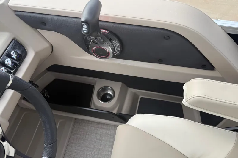 Slide: The Image of 2026 Avalon LSZ Quad Lounger Shift boat interior with steering wheel and control panel. - 25