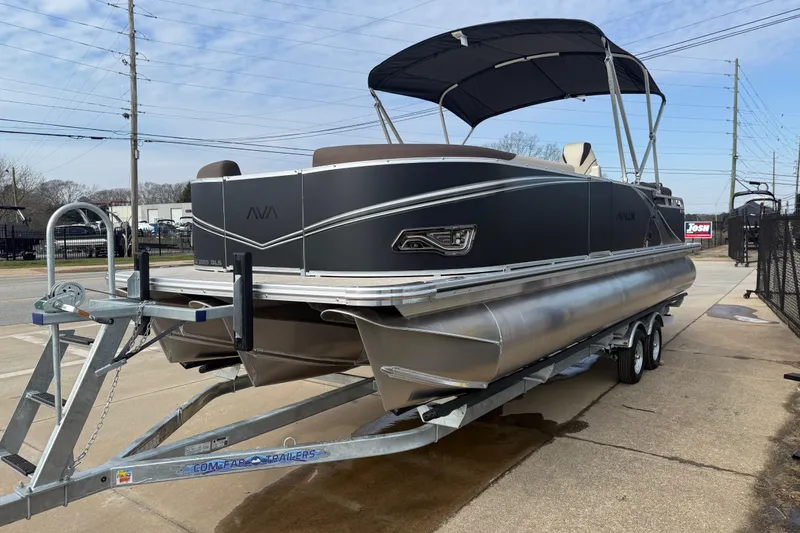 Slide: The Image of 2026 Avalon LSZ Quad Lounger Shift pontoon boat on trailer, outdoor display. - 3