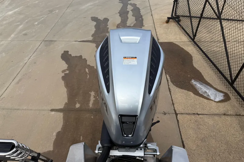 Slide: The Image of Top view of a 2026 Avalon LSZ Quad Lounger Shift boat engine on pavement. - 34
