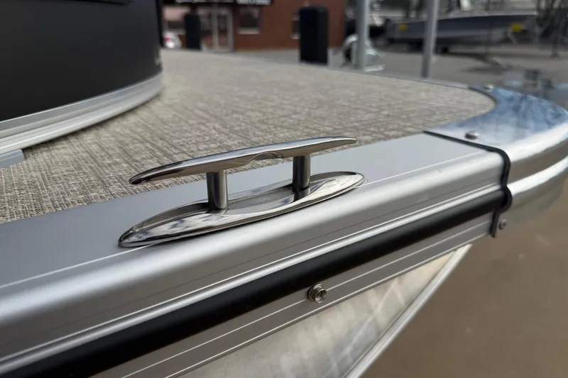 Slide: The Image of 2026 Avalon LSZ Quad Lounger Shift boat cleat on deck, close-up view. - 57