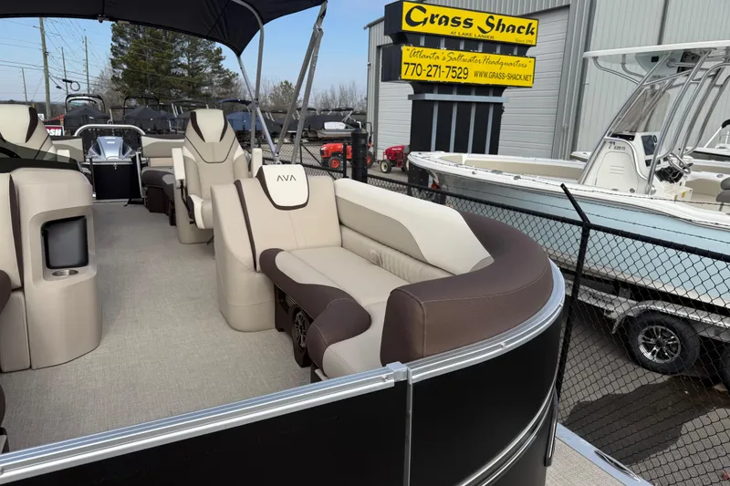 Slide: The Image of 2026 Avalon LSZ Quad Lounger Shift pontoon boat at dealership, featuring luxurious seating. - 8