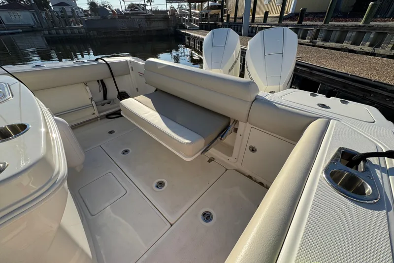 Slide: The Image of 2023 Boston Whaler 250 Outrage boat interior with seating and twin engines. - 10