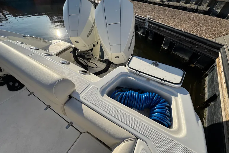 Slide: The Image of 2023 Boston Whaler 250 Outrage boat with Mercury engines and coiled blue hose. - 12