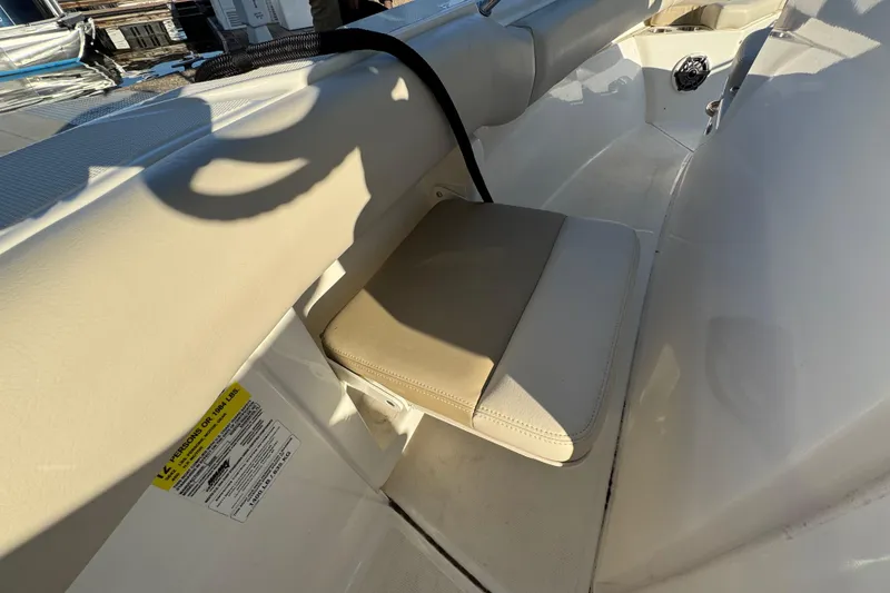 Slide: The Image of 2023 Boston Whaler 250 Outrage interior seating detail with beige cushion. - 16