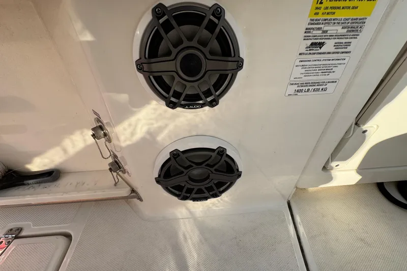 Slide: The Image of 2023 Boston Whaler 250 Outrage boat speakers and safety label detail. - 25