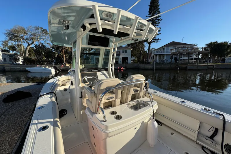 Slide: The Image of 2023 Boston Whaler 250 Outrage boat docked by waterfront homes. - 26