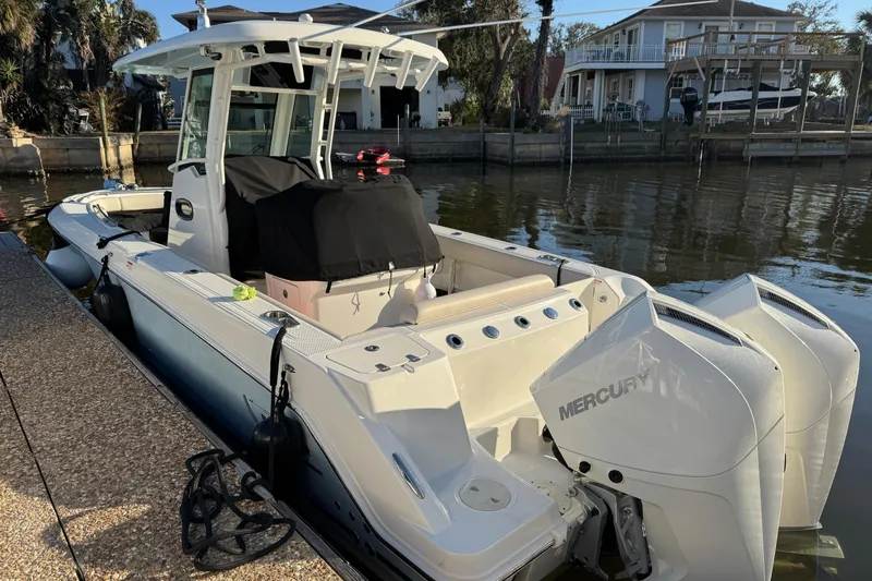 Slide: The Image of 2023 Boston Whaler 250 Outrage boat docked with twin Mercury engines. - 5