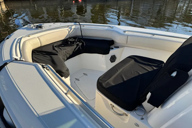 Slide: The Image of 2023 Boston Whaler 250 Outrage boat interior with cushioned seating and cup holders. - 6