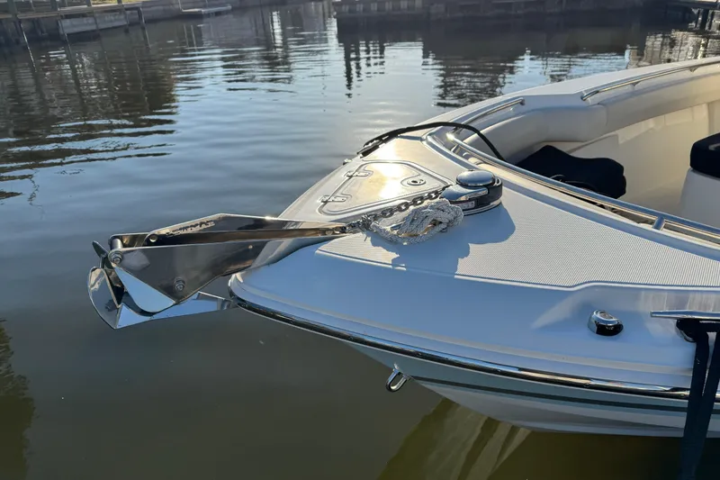 Slide: The Image of 2023 Boston Whaler 250 Outrage bow with anchor, docked on calm water. - 8