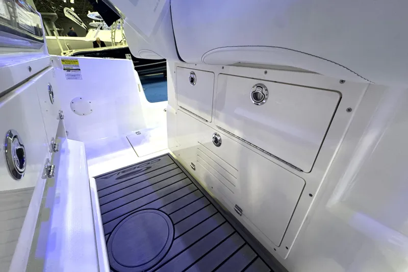 Slide: The Image of 2026 Cobia 245 Center Console boat interior with storage compartments and non-slip flooring. - 13