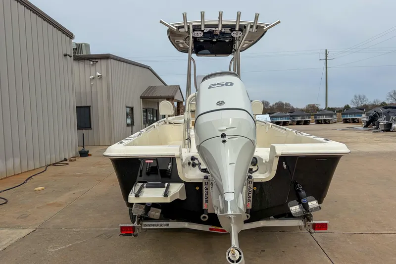 Slide: The Image of 2026 Bulls Bay 2400 boat with powerful 250 engine, parked outdoors. - 11