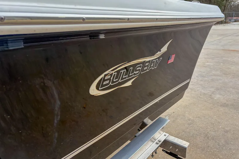 Slide: The Image of 2026 Bulls Bay 2400 boat side view with logo and American flag decal. - 3