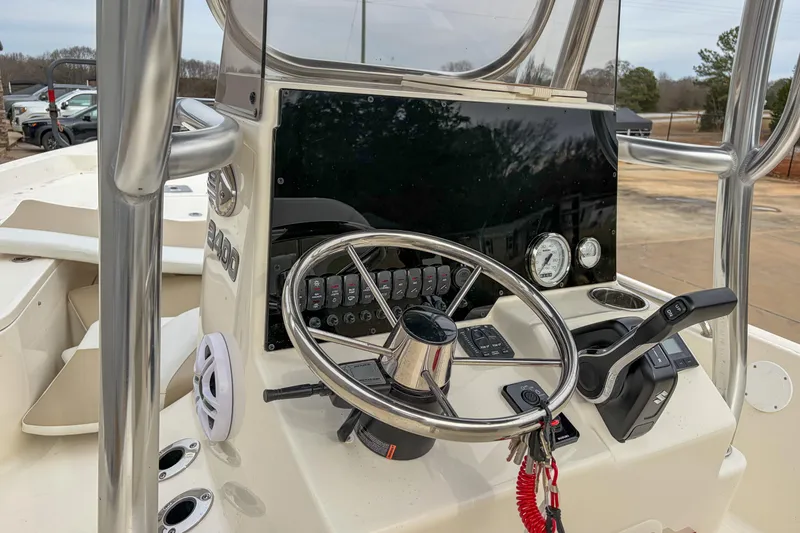 Slide: The Image of 2026 Bulls Bay 2400 boat dashboard with steering wheel and control panel. - 6